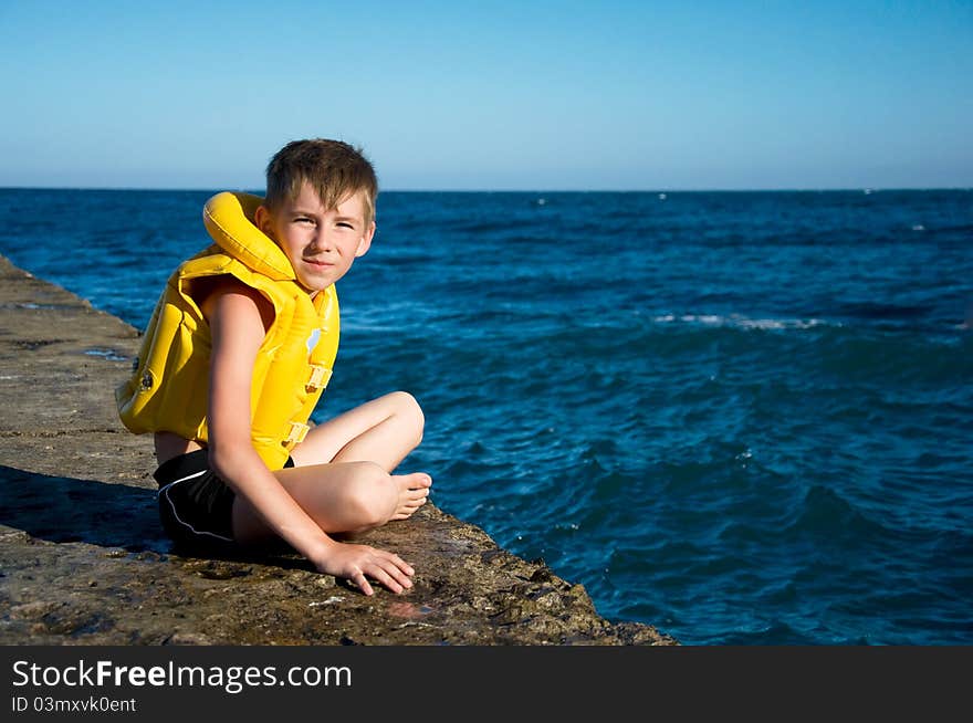 Boy in yellow life jacket