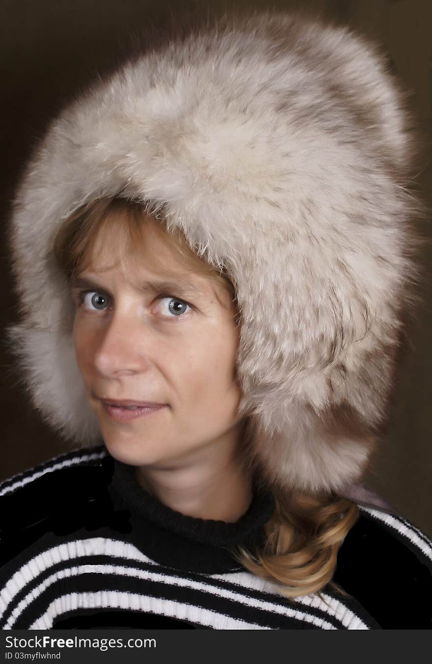 The young woman in a fluffy fur cap.