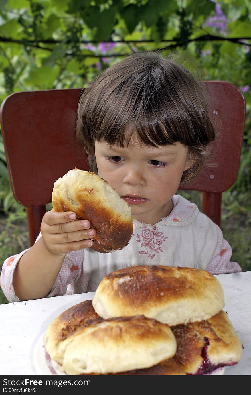 The little girl tastes grandmather pies. The little girl tastes grandmather pies.