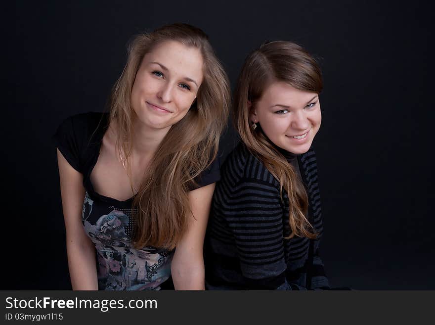 Two friends talking and smiling studio shot