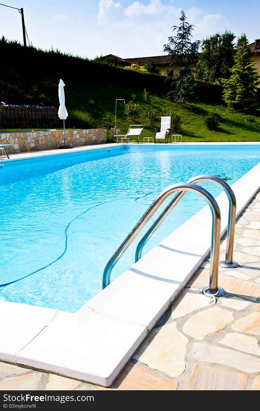 Swimming pool of an Italian beauty farm in the middle vineyards, Monferrato area, Piemonte region. Swimming pool of an Italian beauty farm in the middle vineyards, Monferrato area, Piemonte region.