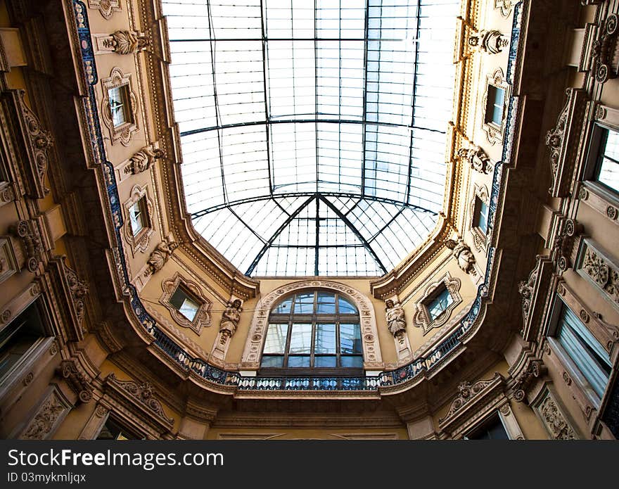 The Galleria Vittorio Emanuele II is a covered double arcade formed of two glass-vaulted arcades at right angles intersecting in an octagon, prominently sited on the northern side of the Piazza del Duomo in Milan. The Galleria Vittorio Emanuele II is a covered double arcade formed of two glass-vaulted arcades at right angles intersecting in an octagon, prominently sited on the northern side of the Piazza del Duomo in Milan.