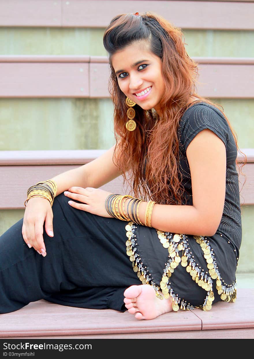 Pakistani model posing with traditional gold ornaments