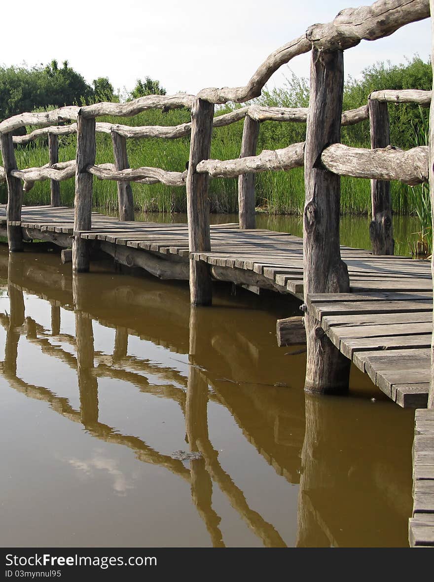 Wood Bridge reflected in water. Wood Bridge reflected in water