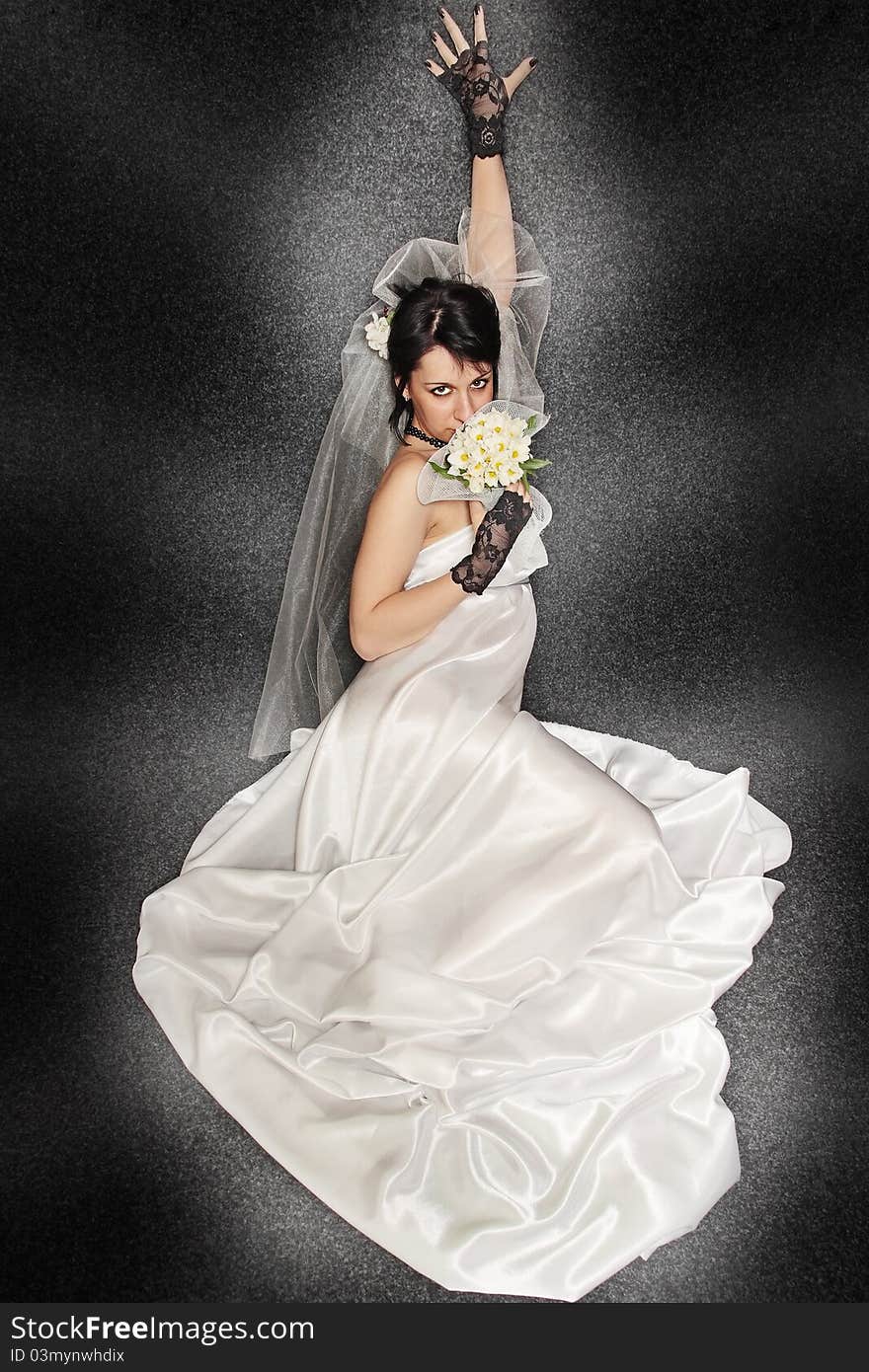 Bride with the bouquet against the dark background. Bride with the bouquet against the dark background