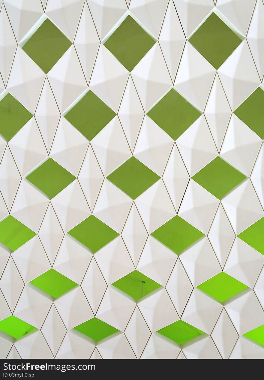 Green rhombs on the grey surface, vertical photo. Green rhombs on the grey surface, vertical photo.