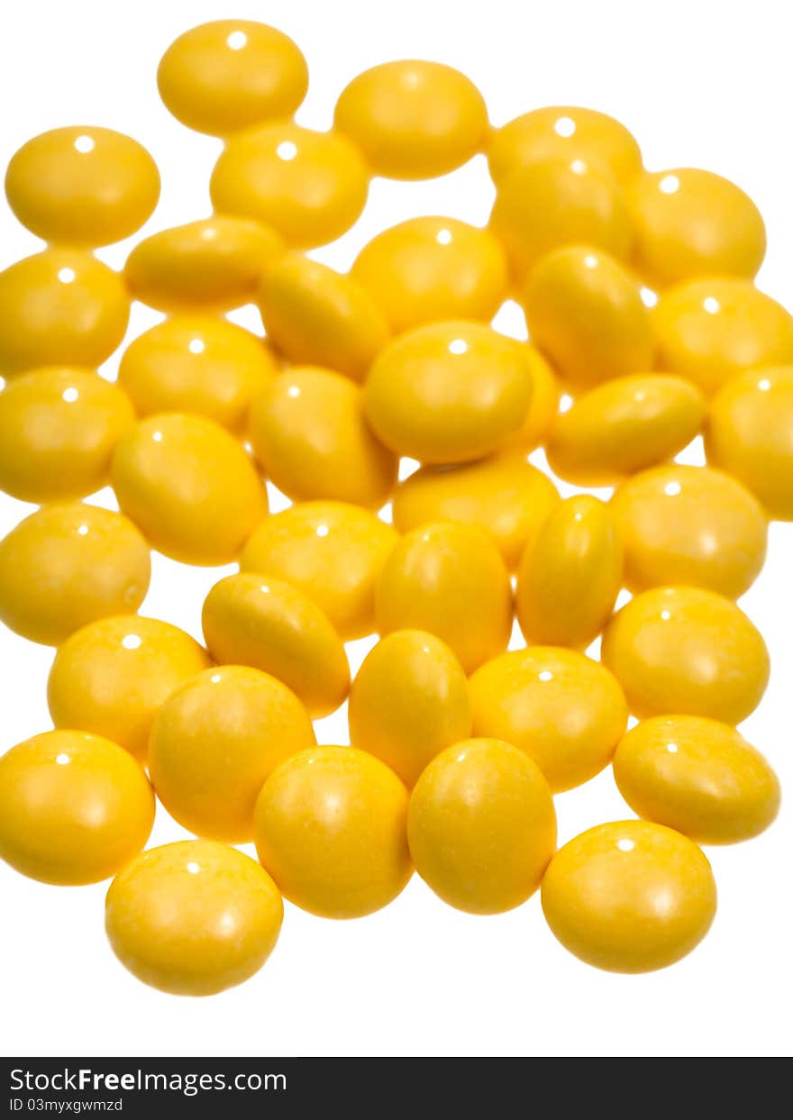 Many yellow vitamin drug close up