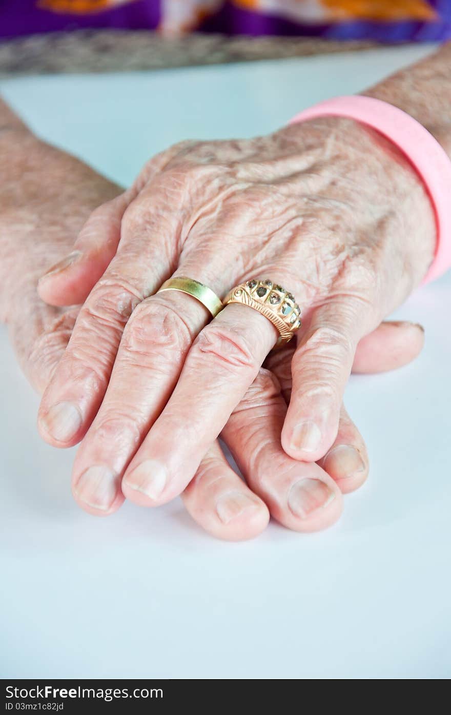 Old woman hand with the golden ring