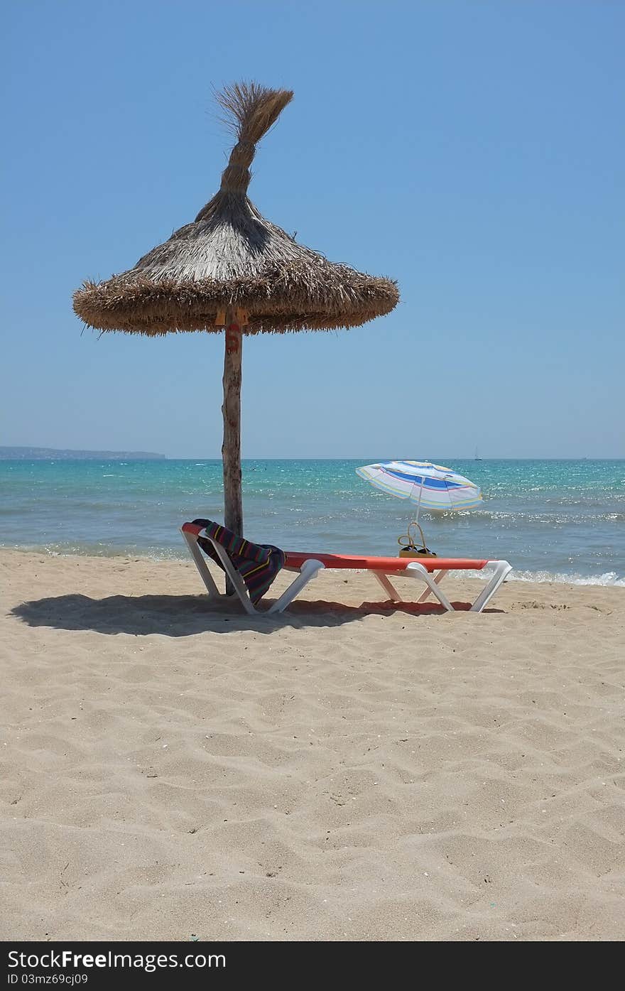 Sunbed under parasol