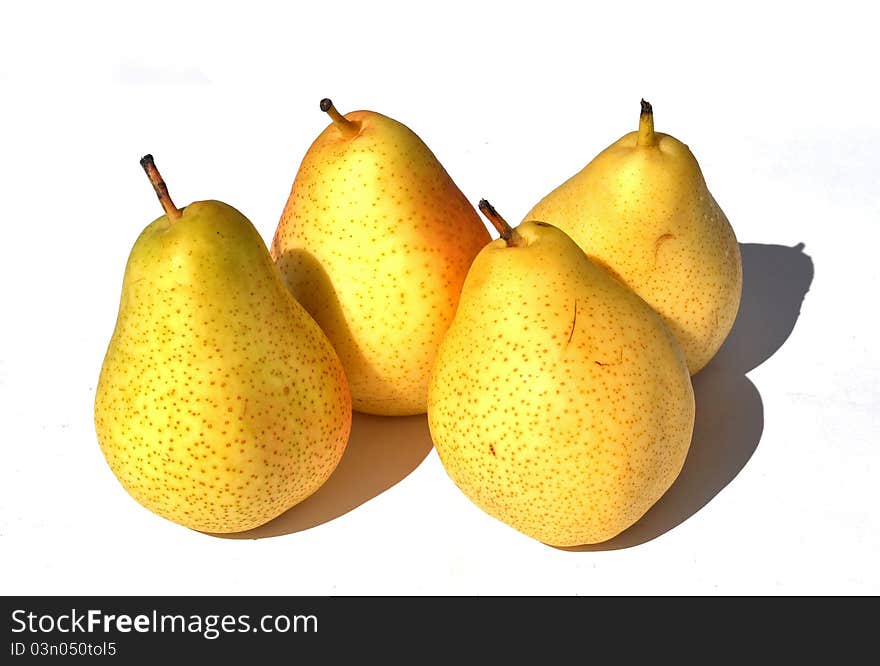 Four yellow pears with their shadow on a white background. Four yellow pears with their shadow on a white background