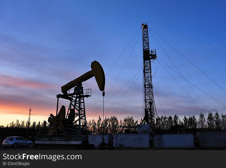 Oil pump silhouette against a bright blue sky