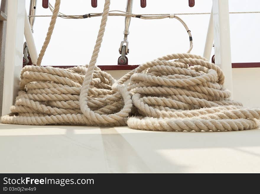 Coiled rope rigging on a sailboat deck.