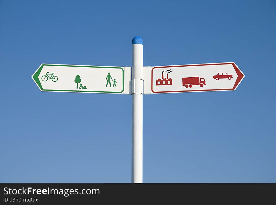 Environmental signpost or road sign showing green arrow to the left and red arrow to the right. Environmental concept image. Environmental signpost or road sign showing green arrow to the left and red arrow to the right. Environmental concept image.