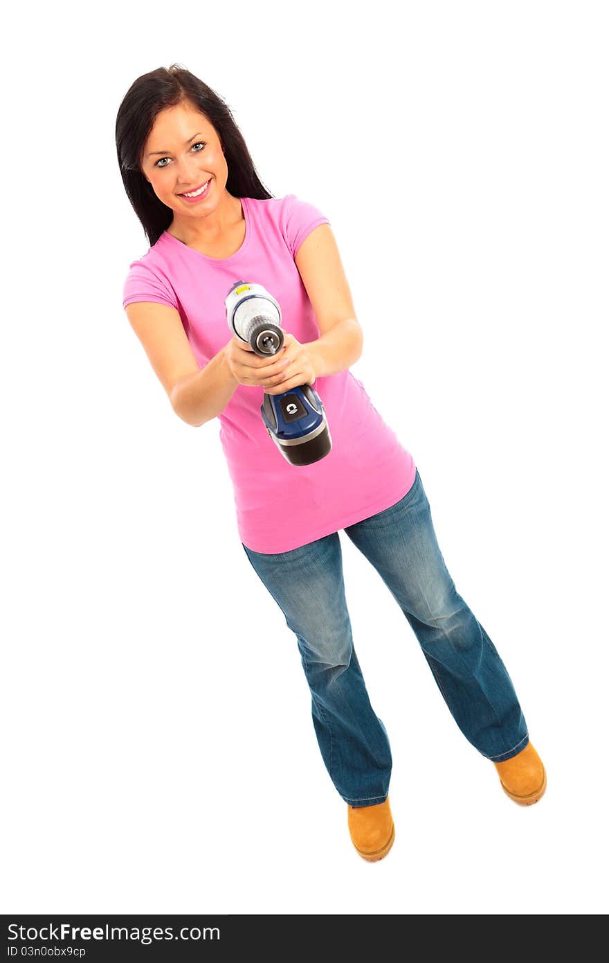 Young female dressed in pink top and blue jeans holding a cordless electric drill on isolated white background. Young female dressed in pink top and blue jeans holding a cordless electric drill on isolated white background.