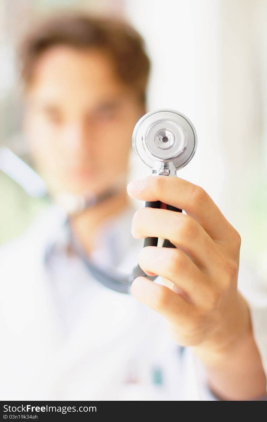 Photo of the doctor holding a stethoscope with copyspace