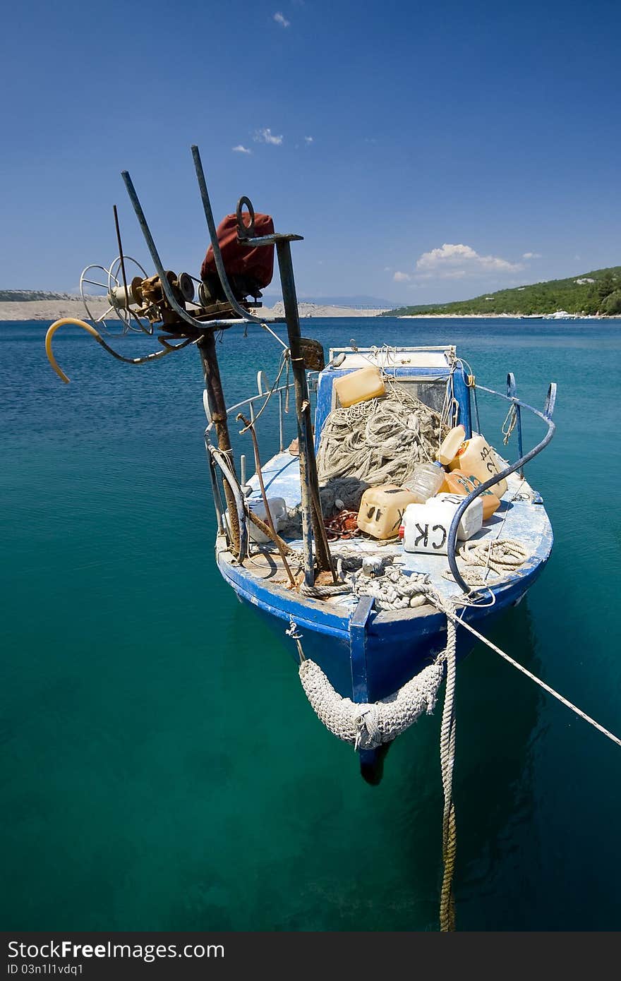 Fishing boat berthed on the coast in the emerald waters in Jadranovo. Fishing boat berthed on the coast in the emerald waters in Jadranovo