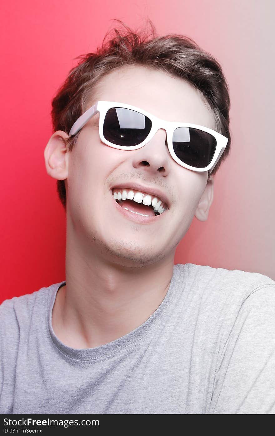 Portrait of a young man on red