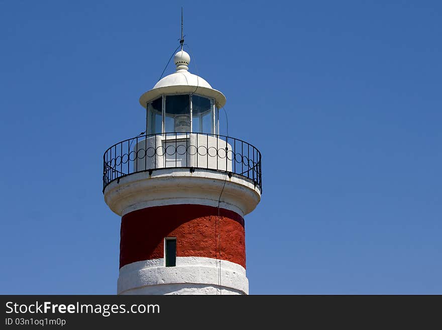 The tower and it`s light of the red nad white lighthouse on cape Ostro in Kraljevica. The tower and it`s light of the red nad white lighthouse on cape Ostro in Kraljevica