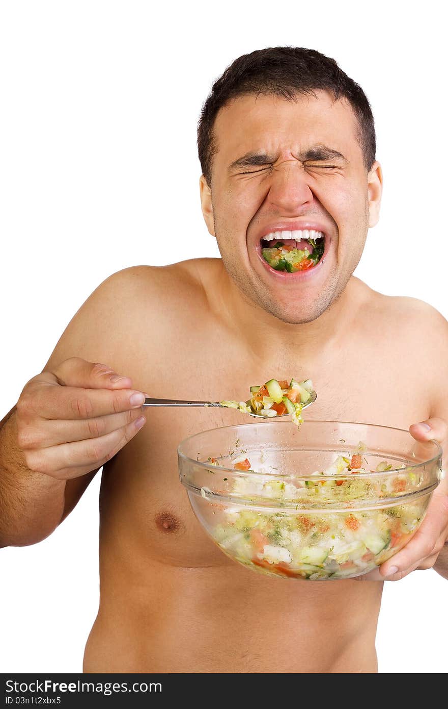 Young happy smiling man eating salad