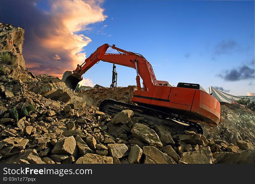 Excavator crushing rocks