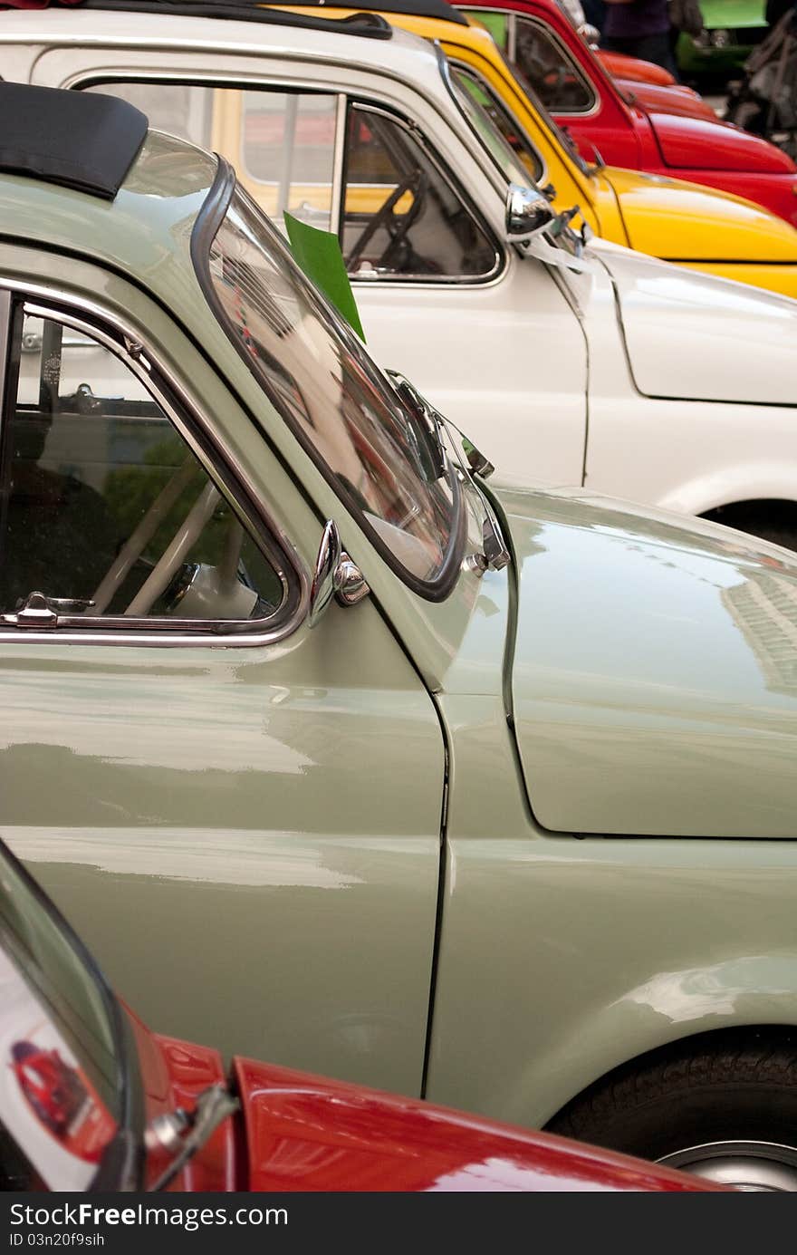 Small mult-coloured cars in a row. Small mult-coloured cars in a row