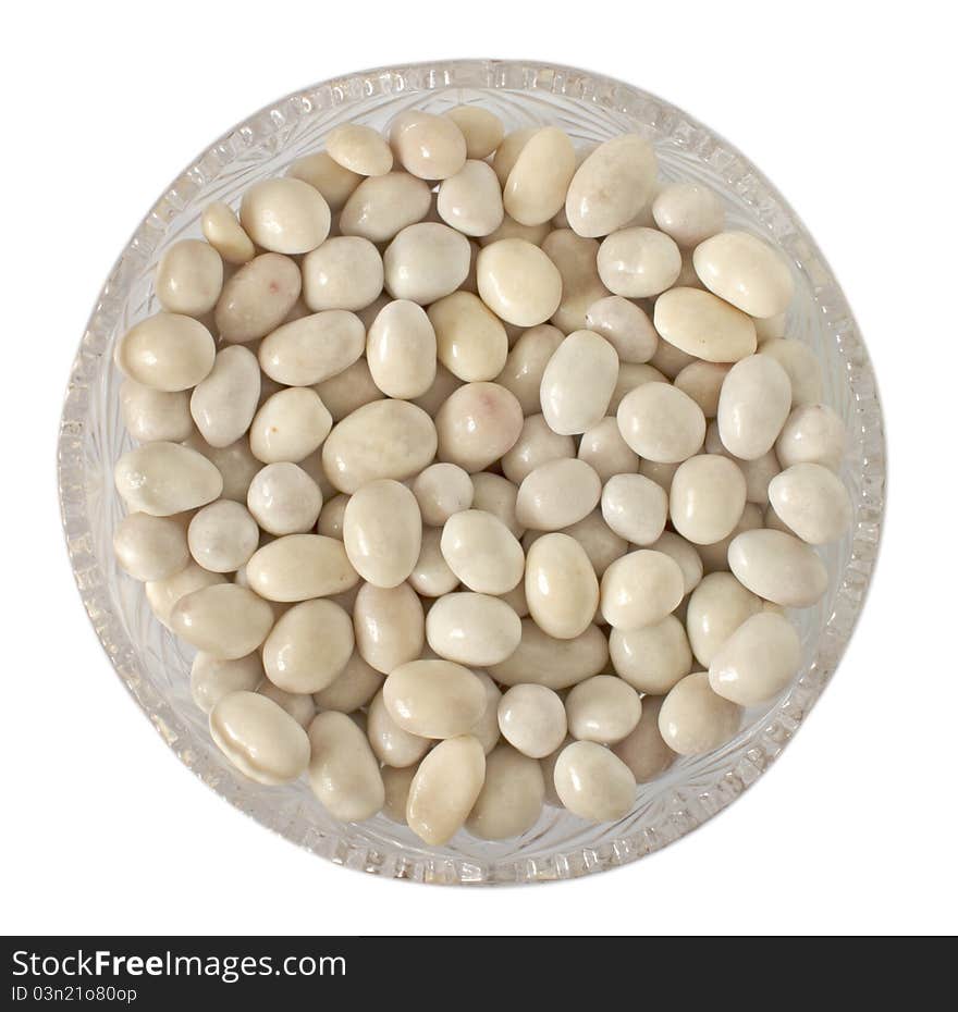 Candy Sea pebbles in a glass vase isolated on white background. Candy Sea pebbles in a glass vase isolated on white background