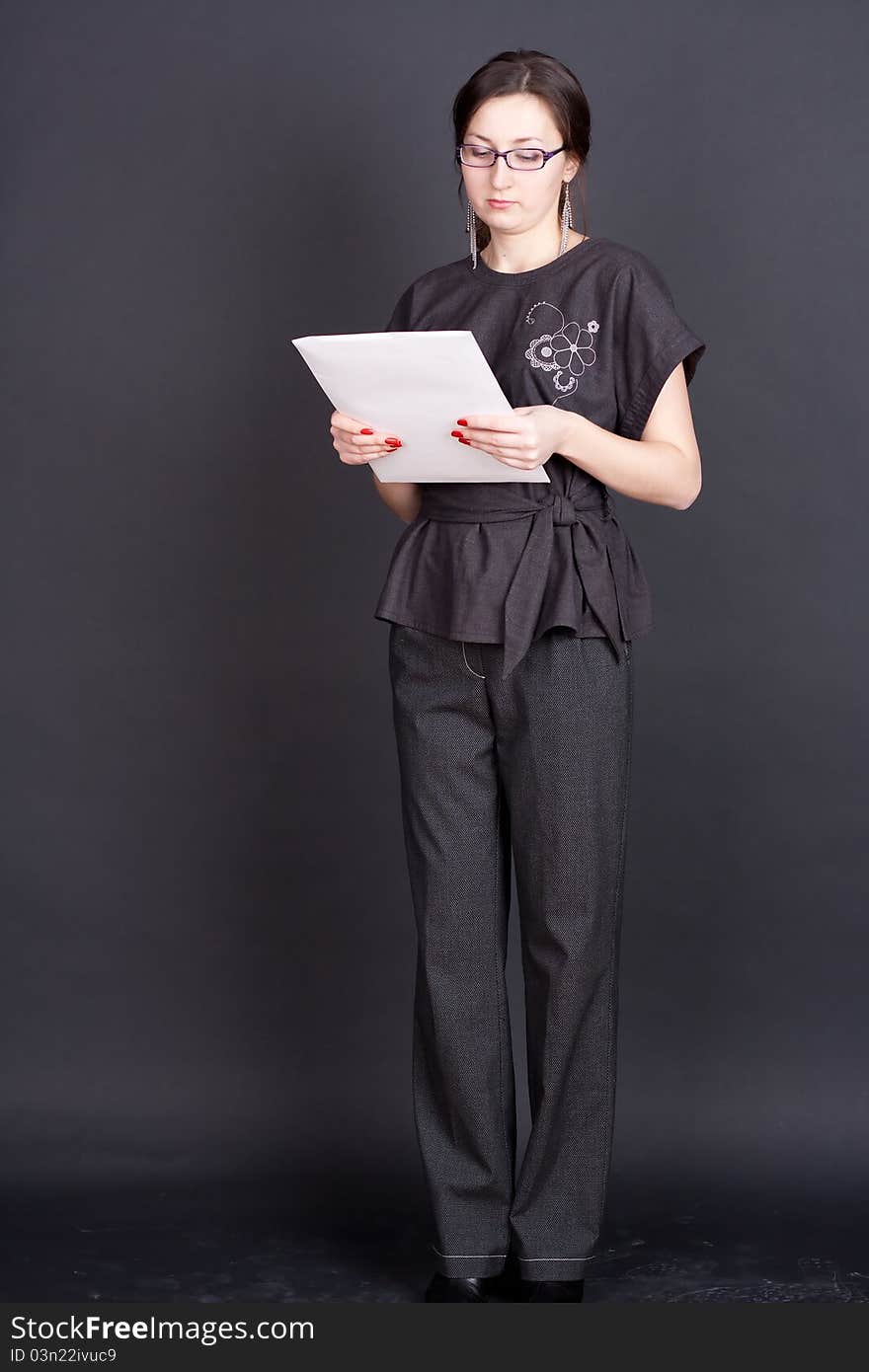 Businesswoman with documents in hand with glasses studio photography