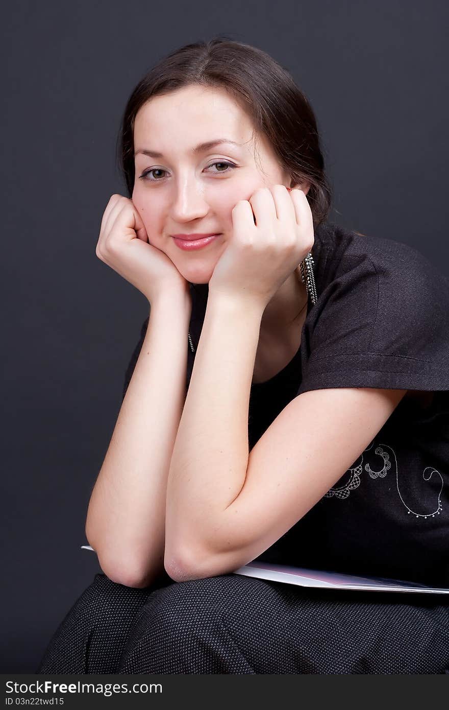 Portrait of a beautiful girl on a dark background studio photography