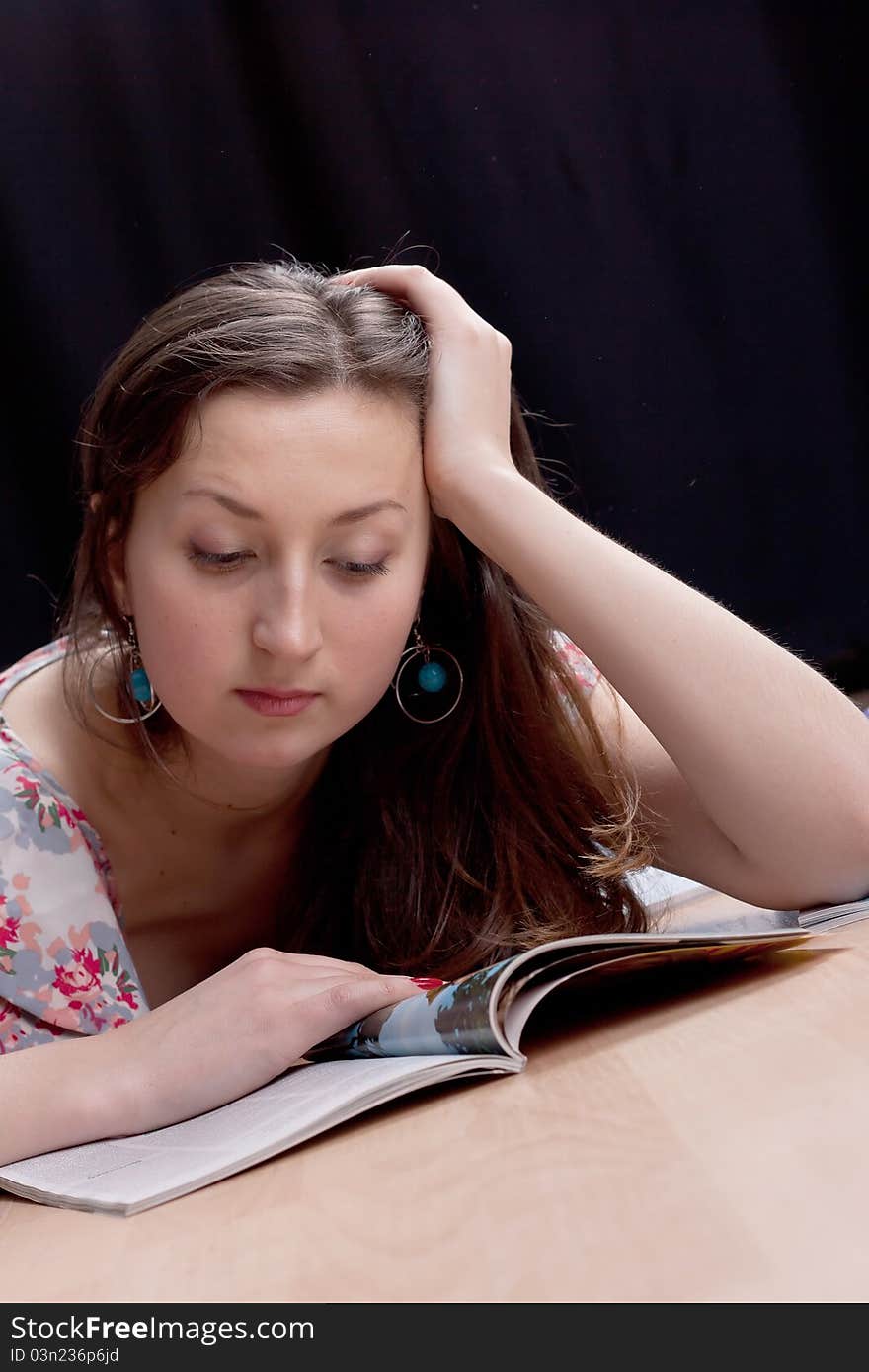 Girl reading a magazine on the floor