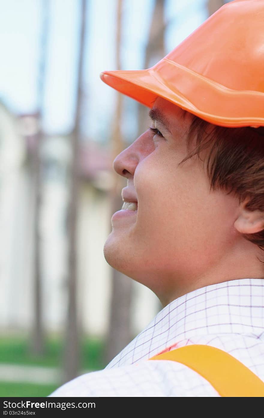 Young worker outdoors looking at the building