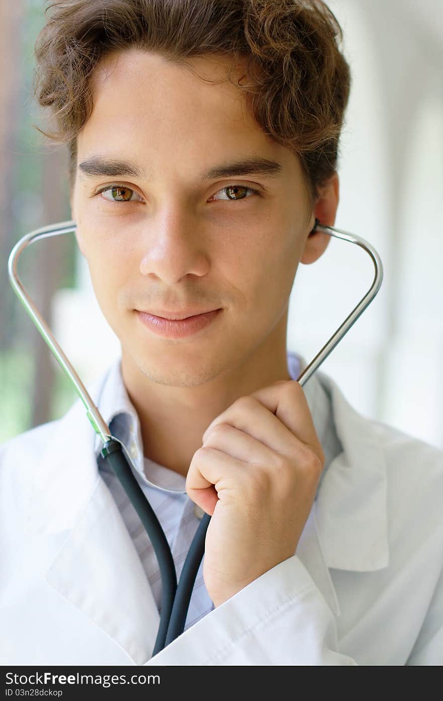 Close-up portrait of young smiling doctor