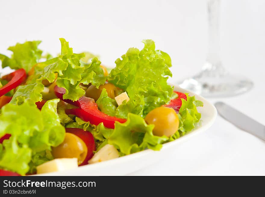 The picture shows a portion of salad. The picture shows a portion of salad