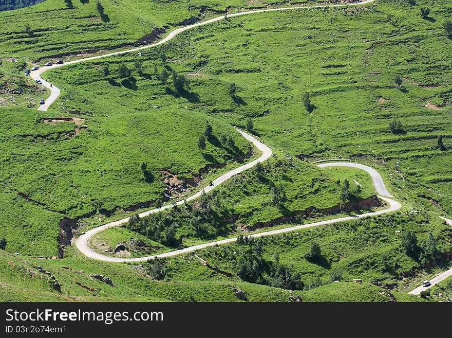 Green grassland and road in great mountain. Green grassland and road in great mountain