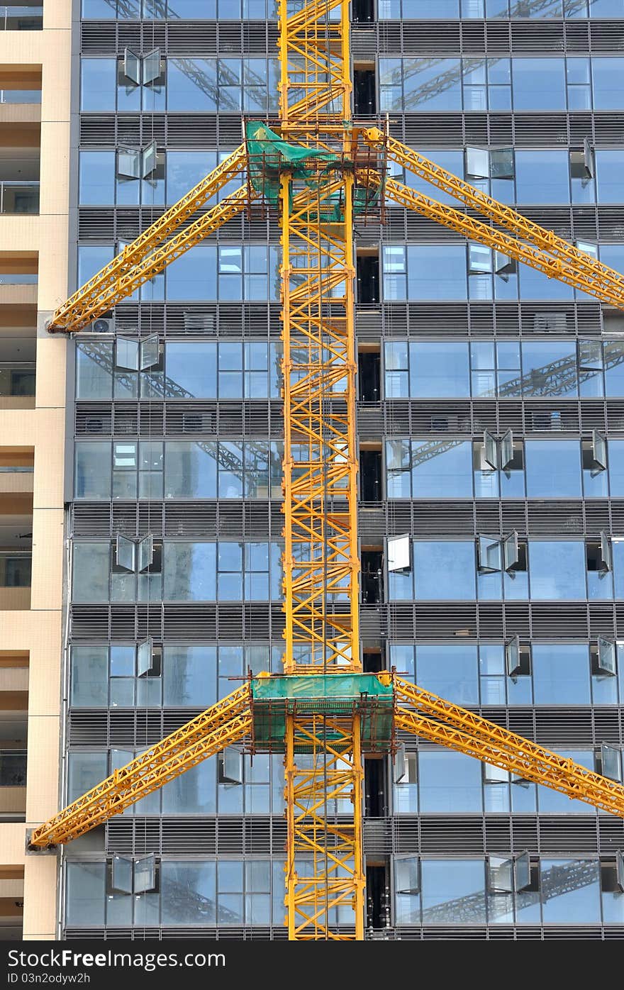 Modern buildings with external glass wall, under construction, shown as modern architecture construction and working place and equipment. Modern buildings with external glass wall, under construction, shown as modern architecture construction and working place and equipment.