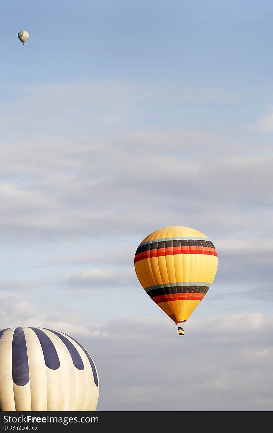 Three Balloons In A Cloudy Sky