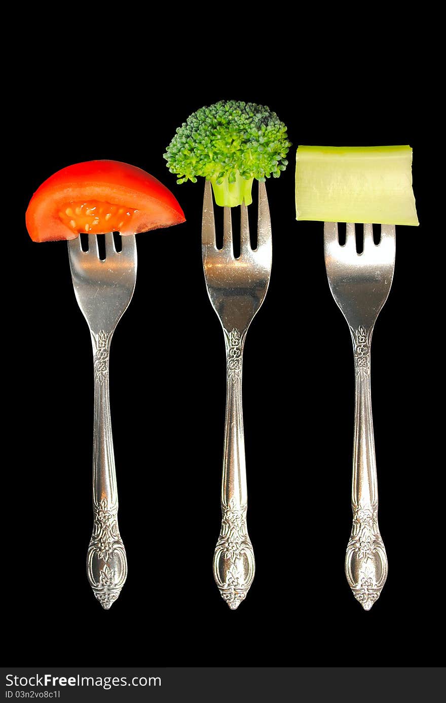 Forks With Vegetables On A Black Background