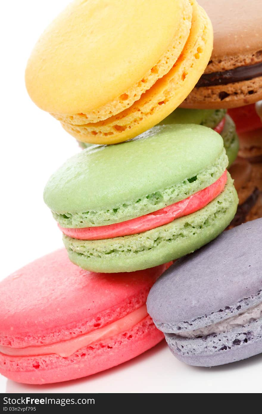 A french sweet delicacy, macaroons variety closeup. White background. A french sweet delicacy, macaroons variety closeup. White background.