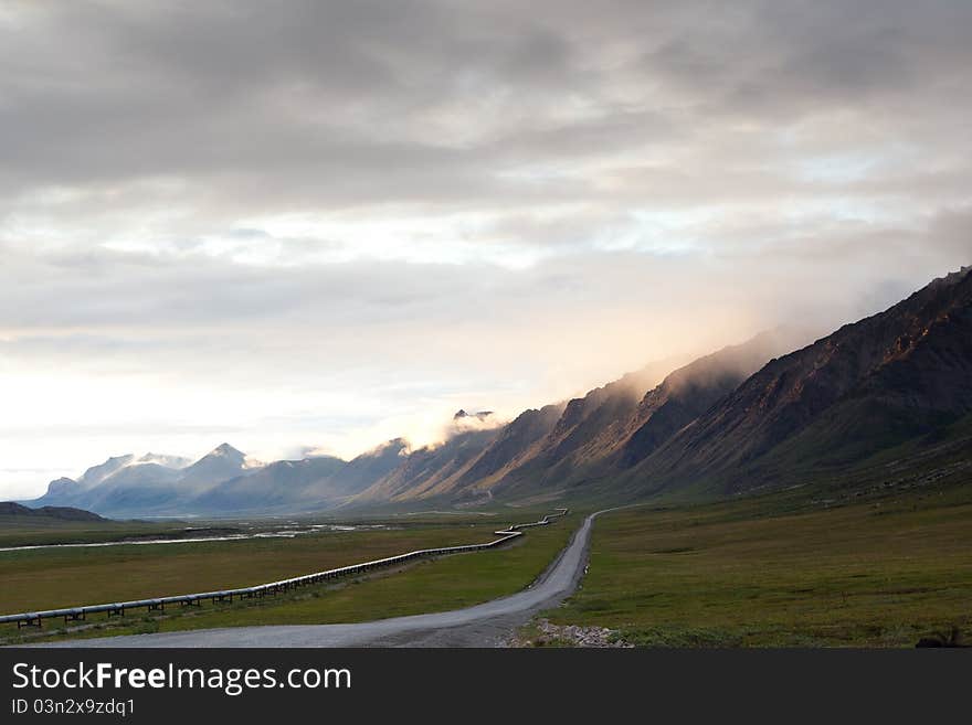 Pipeline with road leading to mountain