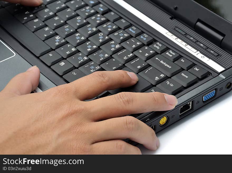 Hand on notebook computer keyboard on whit baclground. Hand on notebook computer keyboard on whit baclground.