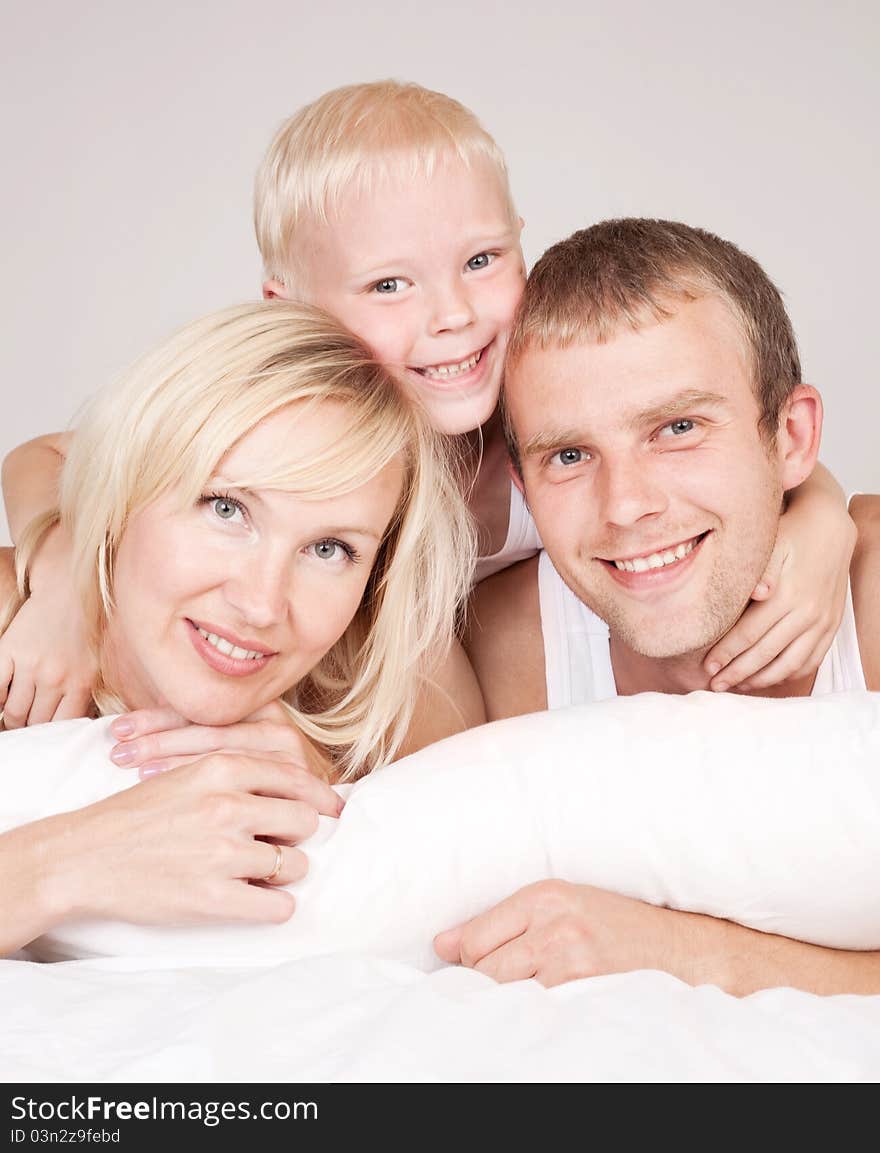 Happy family; mother ,father and their son in  bed at home. Happy family; mother ,father and their son in  bed at home