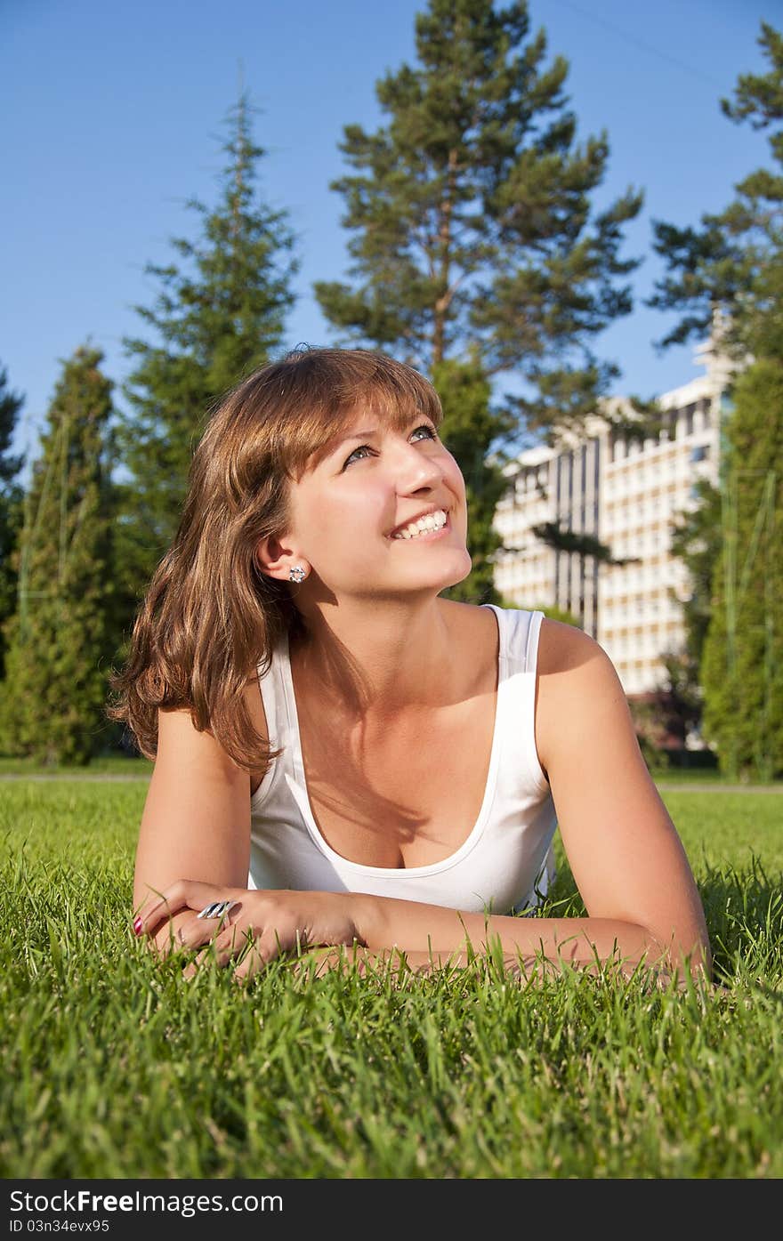 Beautiful young woman smiling in a field