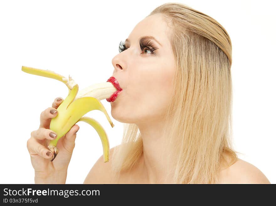 Portrait of attractive Blond woman with lengthen eyelashes sucking banana with red lips, isolated on white. Portrait of attractive Blond woman with lengthen eyelashes sucking banana with red lips, isolated on white