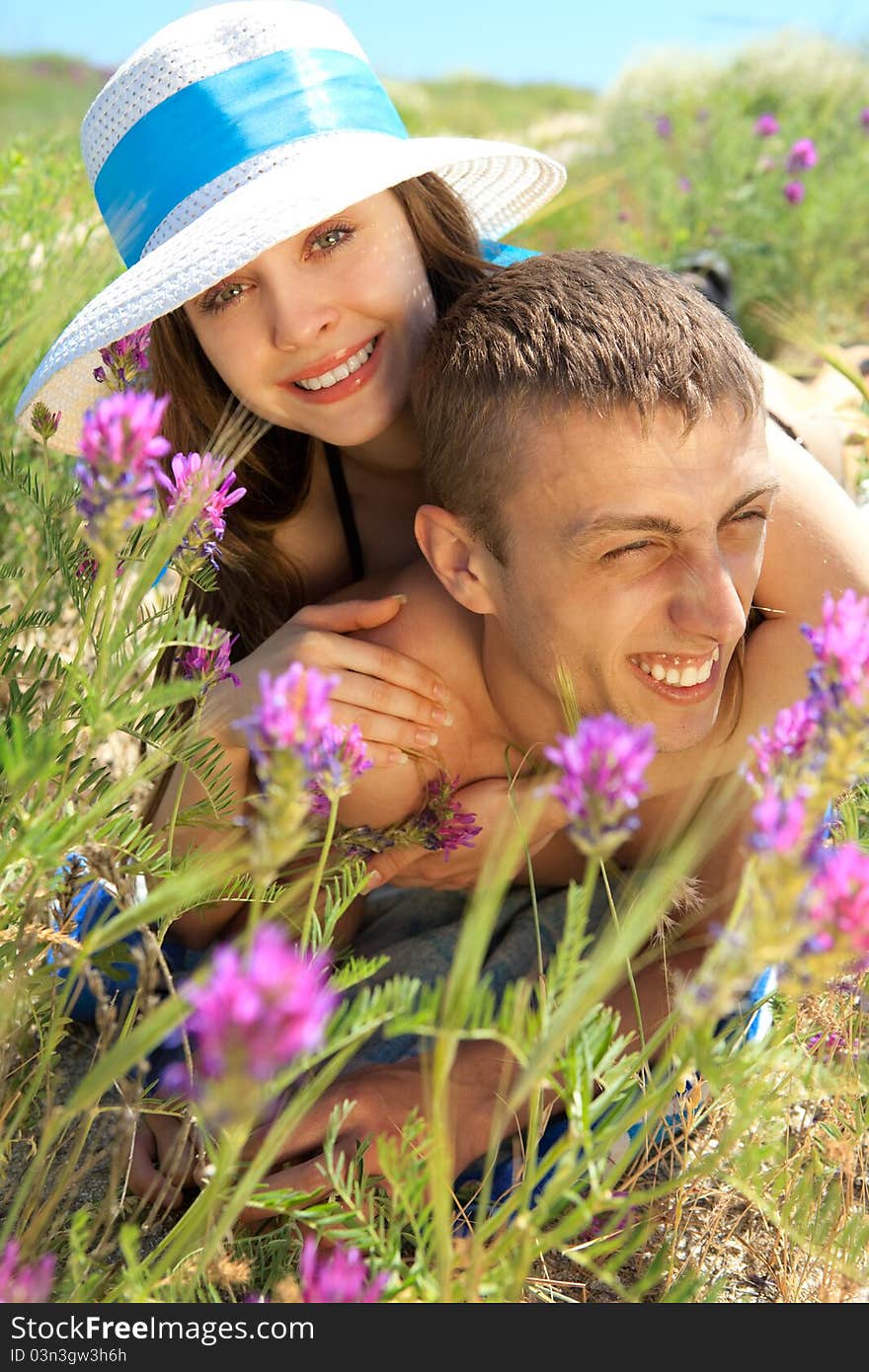 Young Couple Lying On Grass