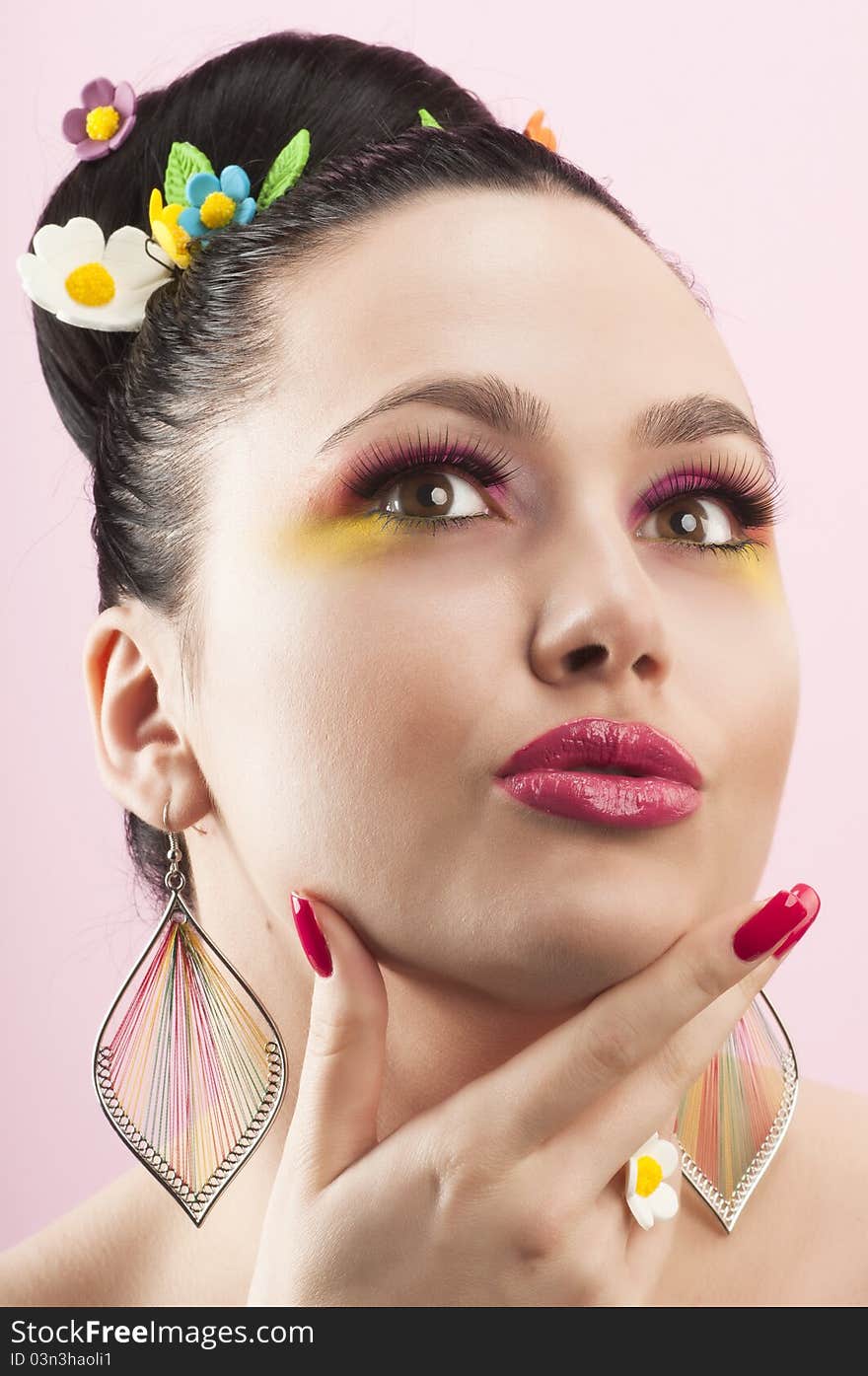 Close-up portrait of beautiful brunette with glamor make-up and color candy style