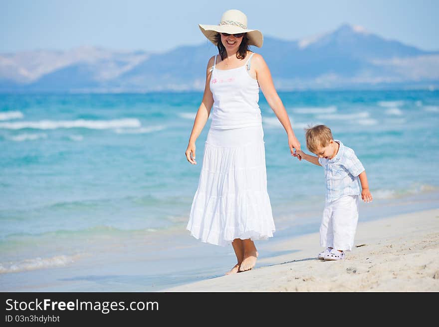 Young mother with her son on beach vacation