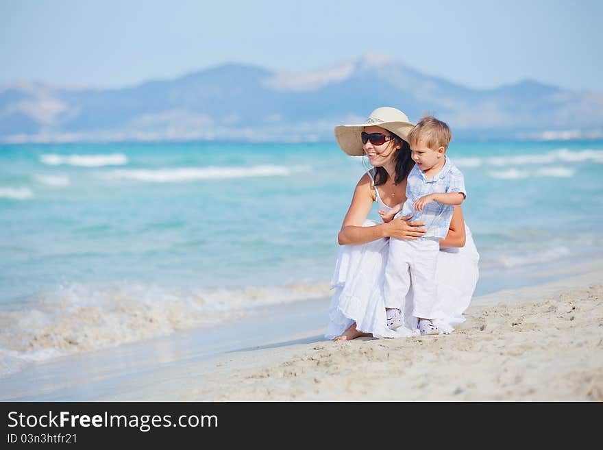 Young mother with her son on tropical beach vacation. Young mother with her son on tropical beach vacation