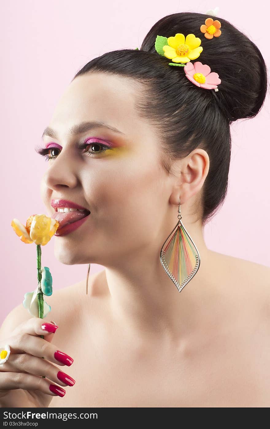 Close-up portrait of beautiful brunette with glamor make-up and color candy style