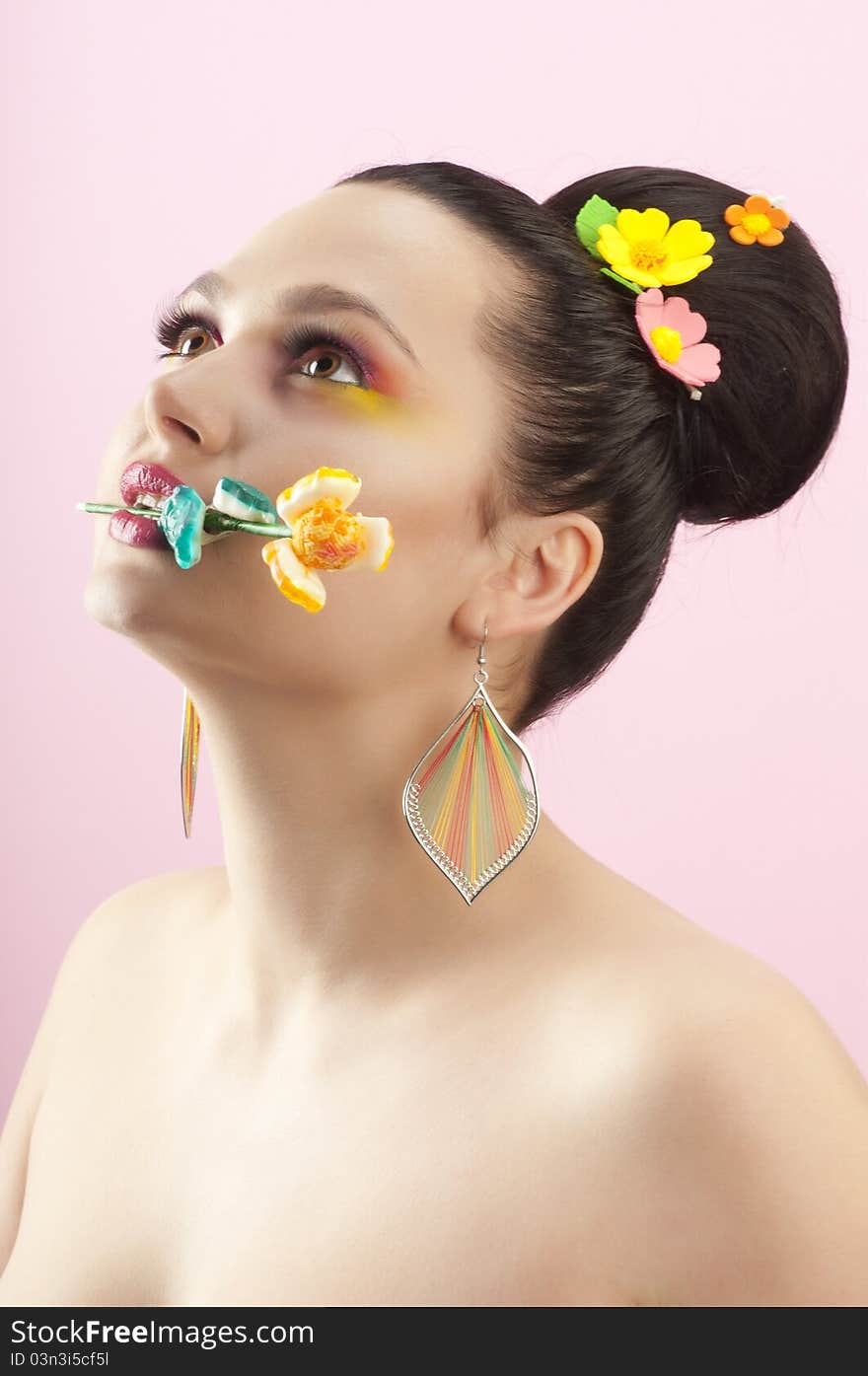 Close-up portrait of beautiful brunette with glamor make-up and color candy style