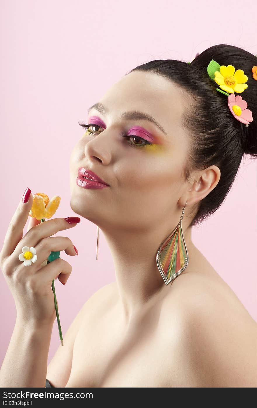 Close-up portrait of beautiful brunette with glamor make-up and color candy style