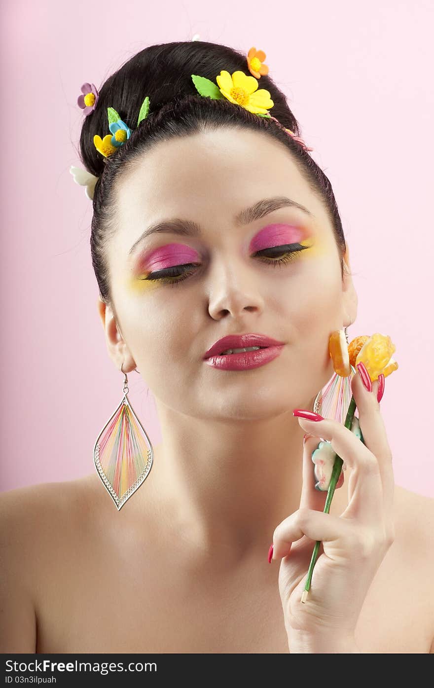 Close-up portrait of beautiful brunette with glamor make-up and color candy style